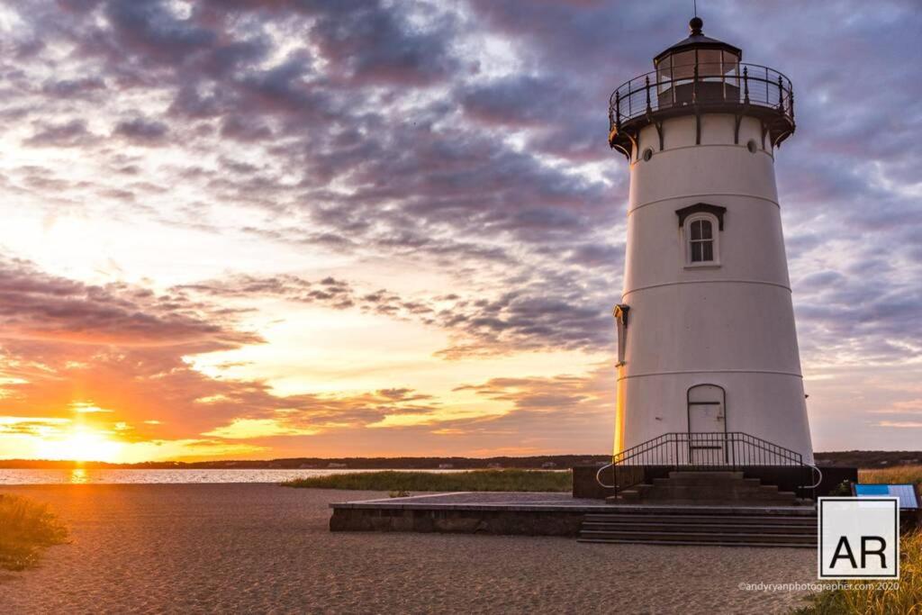 a lighthouse with the sunset in the background at Martha's Vineyard Vacation Home in Edgartown