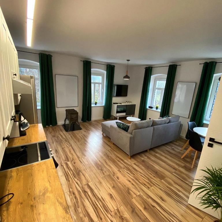 un soggiorno con divano e pavimenti in legno di Countryside Retreat a Janowice Wielkie