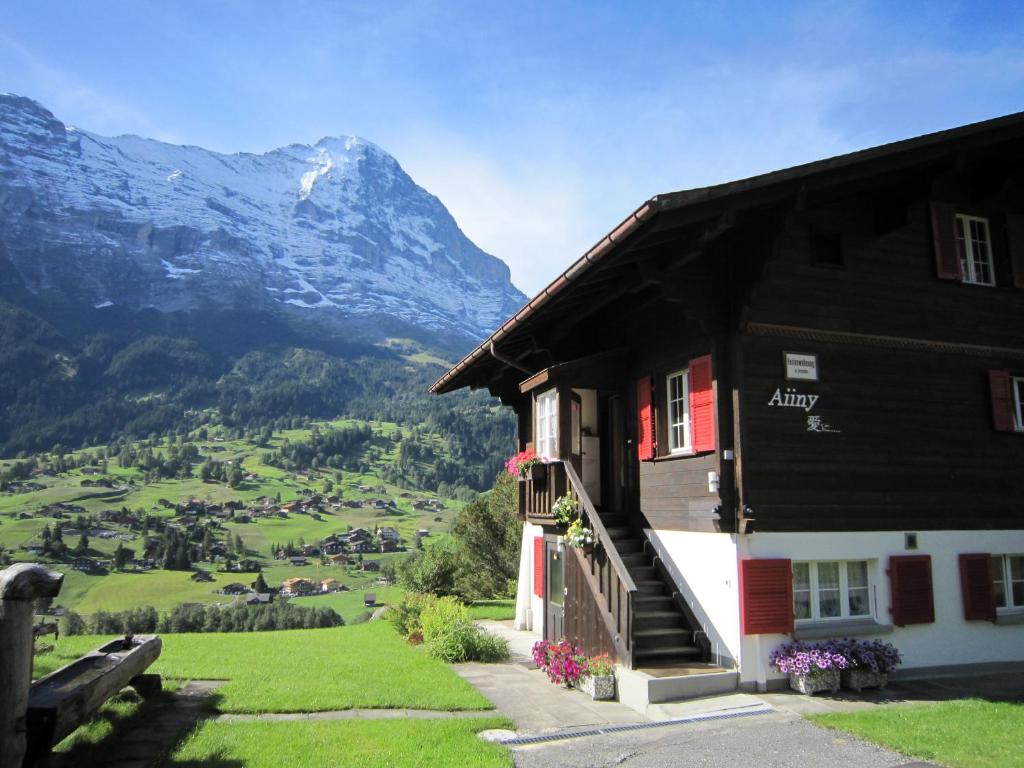 a black and white building with a view of a mountain at Chalet Aiiny in Grindelwald