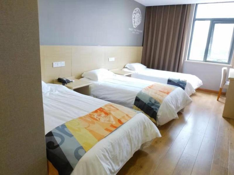 Postel nebo postele na pokoji v ubytování Shell Ningbo Yuyao Xinjian Road Hotel