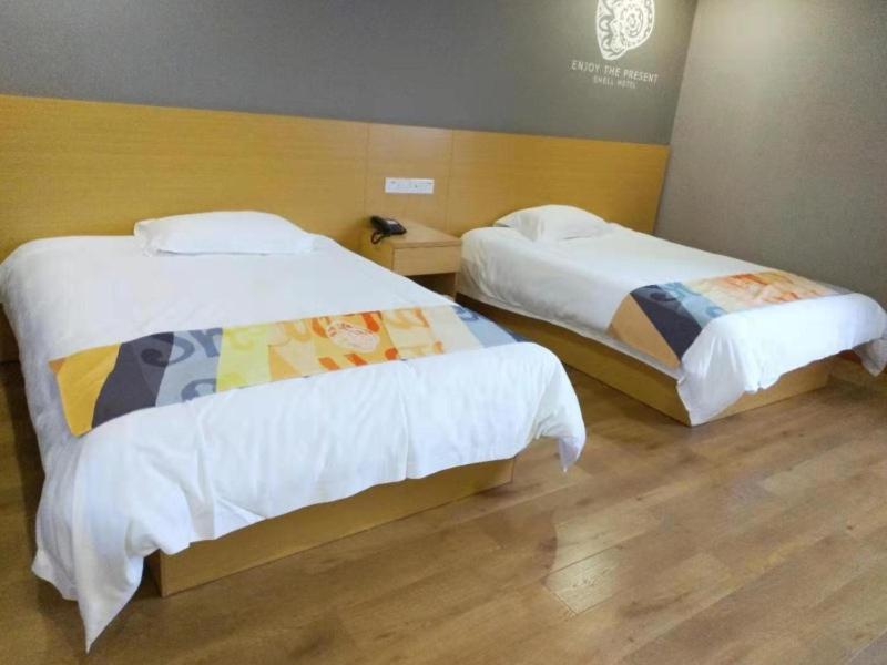 Postel nebo postele na pokoji v ubytování Shell Ningbo Yuyao Xinjian Road Hotel