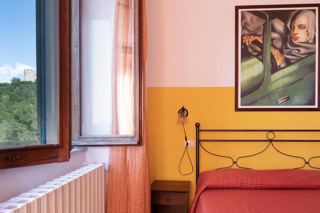 Łóżko lub łóżka w pokoju w obiekcie Osteria Belvedere
