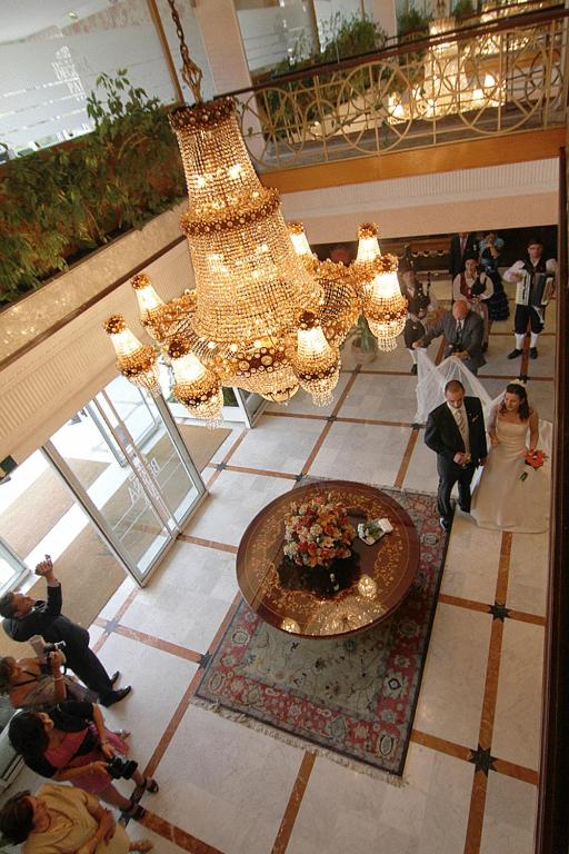 a large chandelier in a building with a wedding party at Hotel Begoña Park in Gijón