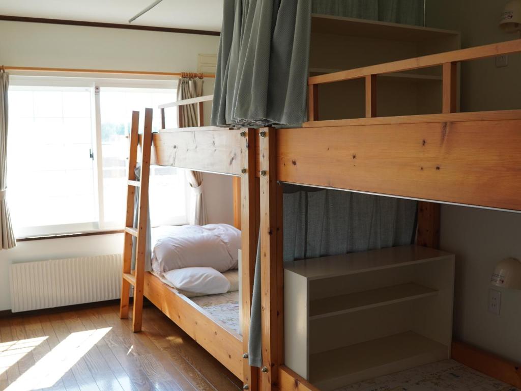 Postel nebo postele na pokoji v ubytování Kiyosato IHATOV Hostel