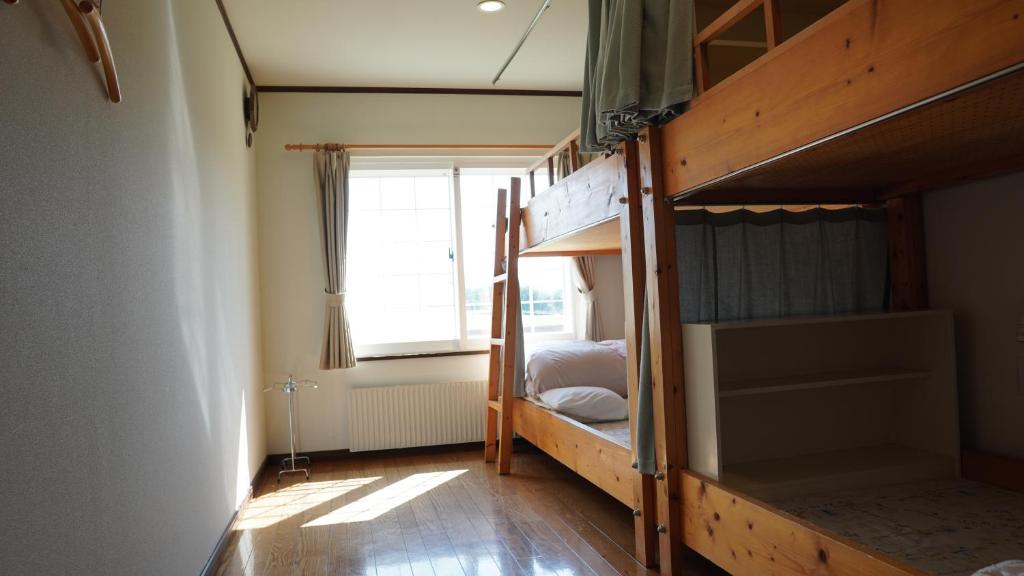 Postel nebo postele na pokoji v ubytování Kiyosato IHATOV Hostel