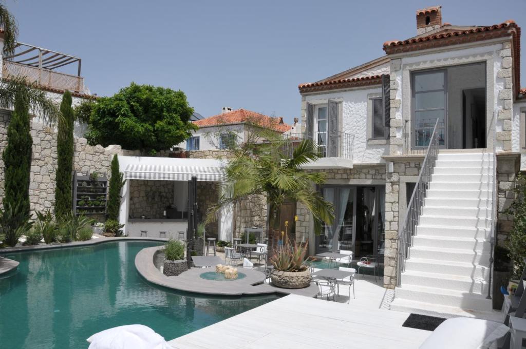 a villa with a swimming pool and a house at Alaçatı Ala Hotel - Special Category in Alacati