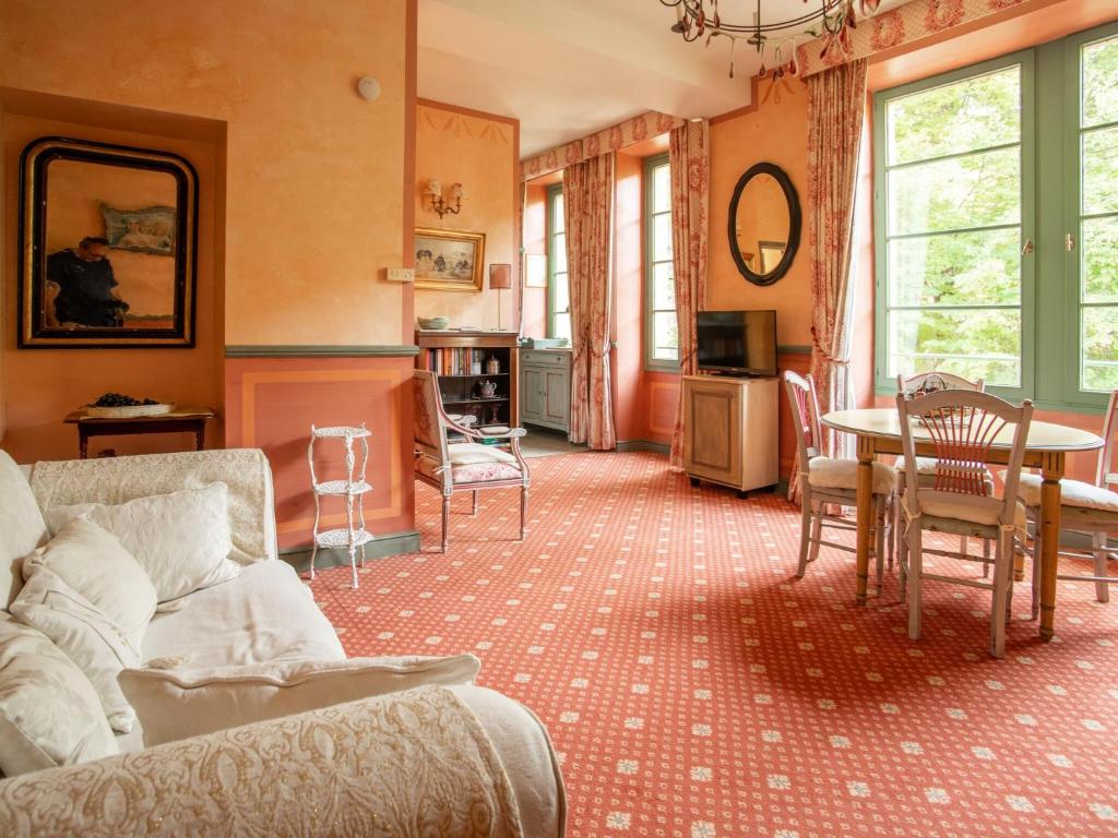 a living room with a couch and a table and chairs at Studio with pool in garden Park naerby spas and views at the Mont Ventoux in Montbrun-les-Bains