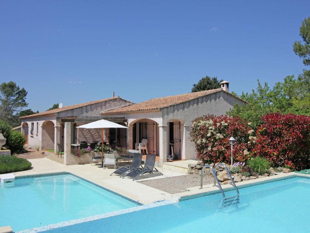 a swimming pool in front of a house at Gorgeous Villa in Bagnols en For t in Bagnols-en-Forêt
