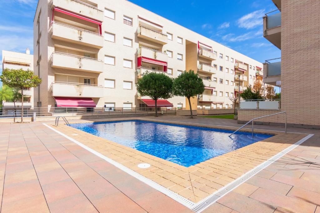 a swimming pool in front of a building at Elegant Apartment in Lloret de Mar, 85 m² with Pool in Lloret de Mar