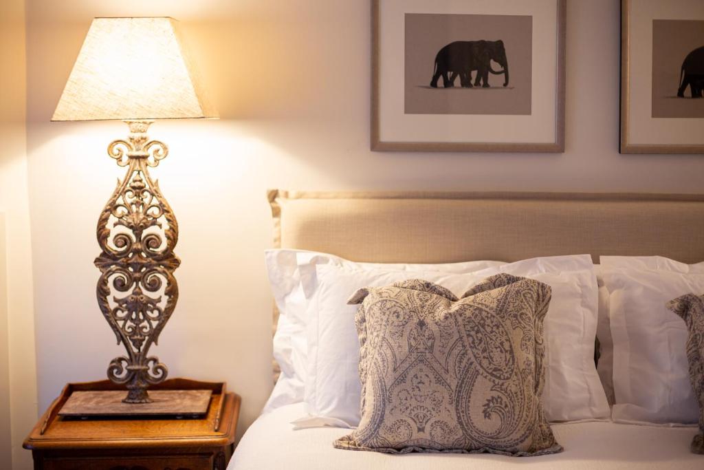 a bedroom with a bed with a lamp on a night stand at The Rivulet in Hobart