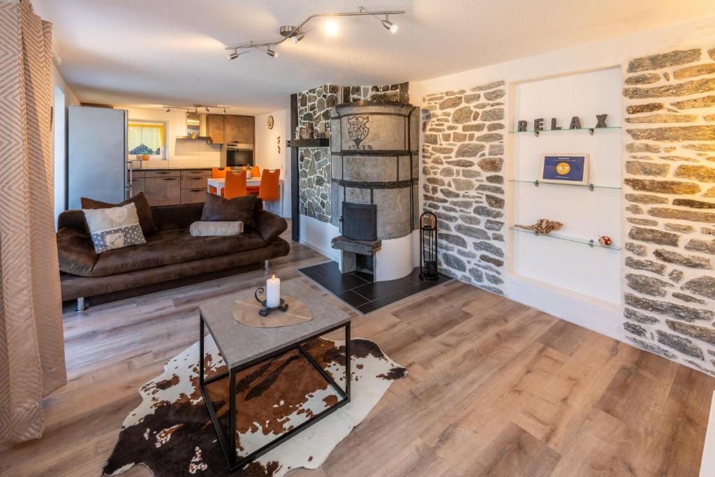 a living room with a brick wall at Chalet Ramona in Grächen