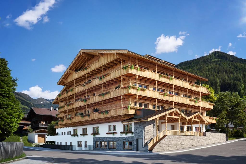 a large wooden building with balconies on the side of a street at Galtenberg Bed & Breakfast in Alpbach