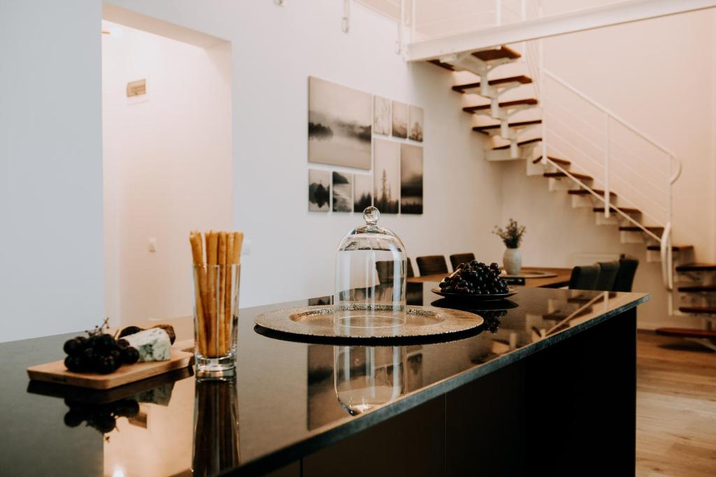 a room with a staircase and a counter with a table at ZEN Central Apartments in Cluj-Napoca