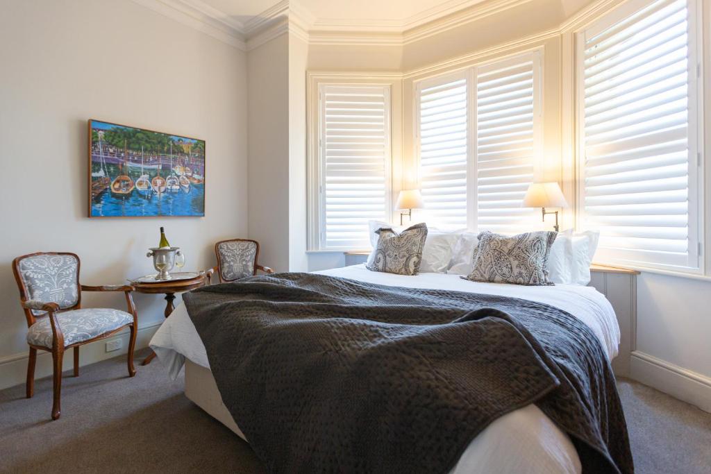 a bedroom with a bed and a table and chairs at The Rivulet in Hobart