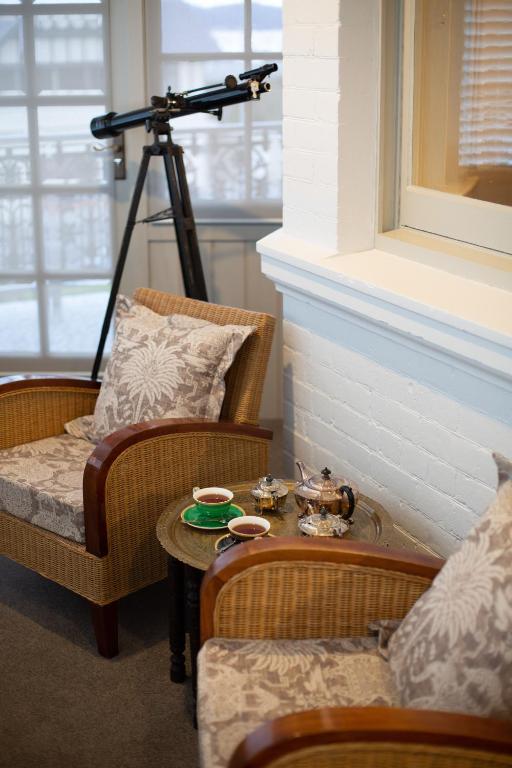 a room with two chairs and a table and a telescope at The Rivulet in Hobart