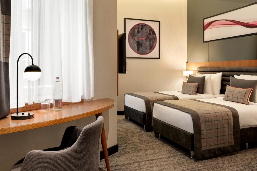 Postel nebo postele na pokoji v ubytování Ramada by Wyndham Budapest City Center