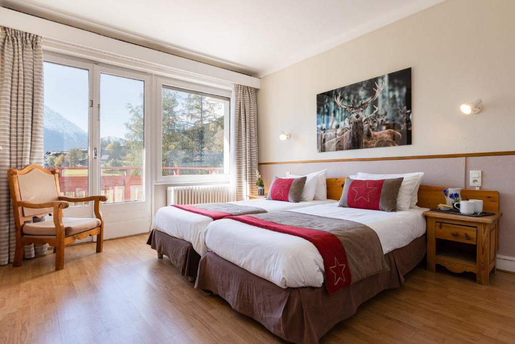 Postel nebo postele na pokoji v ubytování Chalet Hôtel La Sapinière