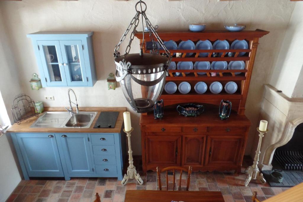 a kitchen with a sink and a chandelier at Die Kleine Auszeit in Wadern