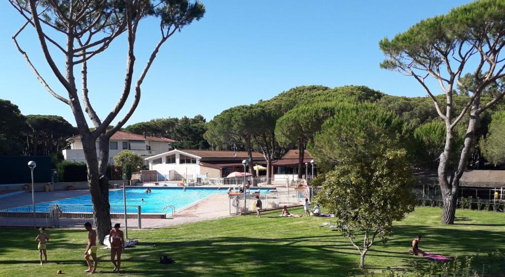 een groep mensen in een park bij een zwembad bij Campeggio del Forte in Marina di Bibbona