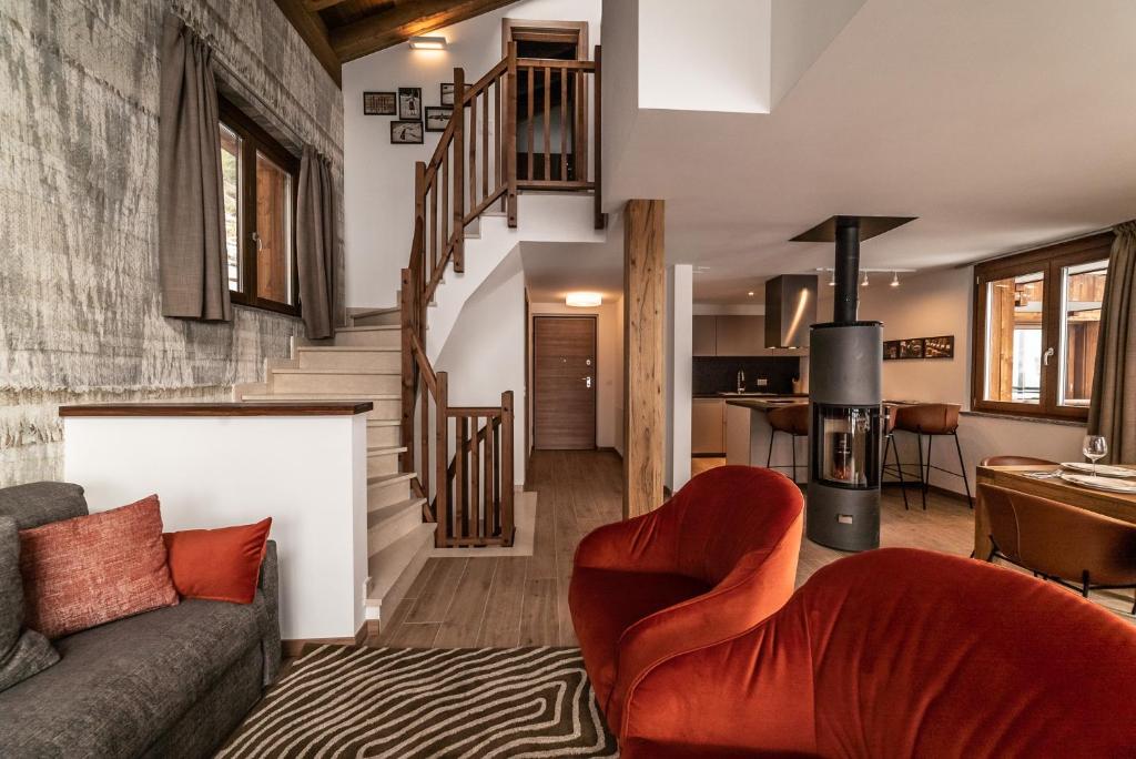 a living room with a couch and a staircase at Chalet Pinnacle in Saas-Fee