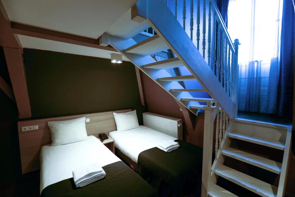 Postel nebo postele na pokoji v ubytování City Hotel Amsterdam
