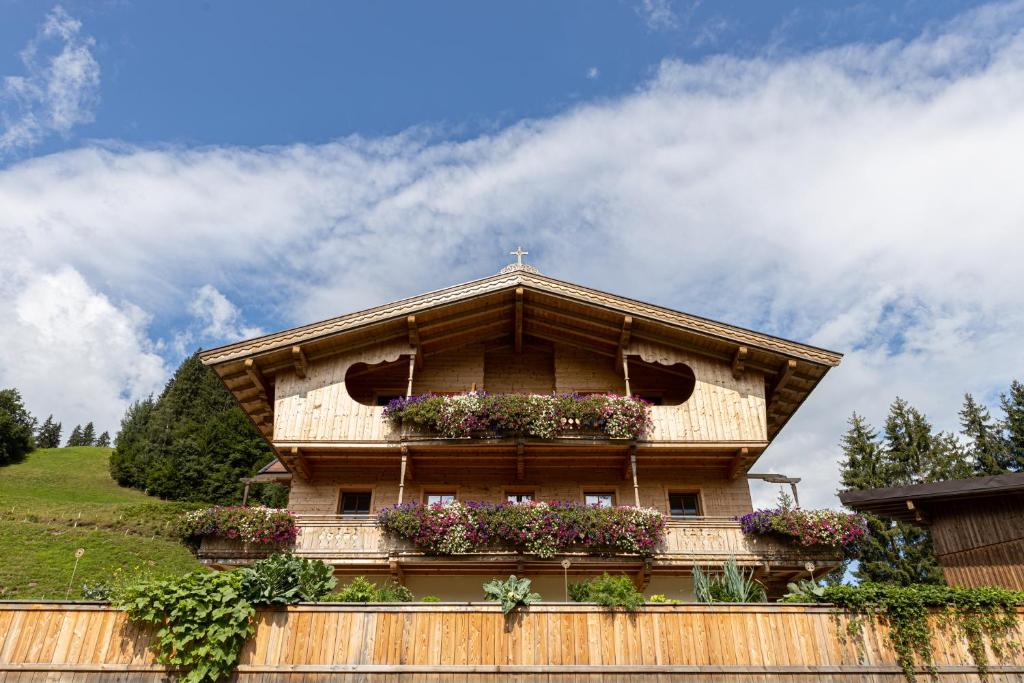 a building with flower boxes on top of it at Oberfasser in Westendorf