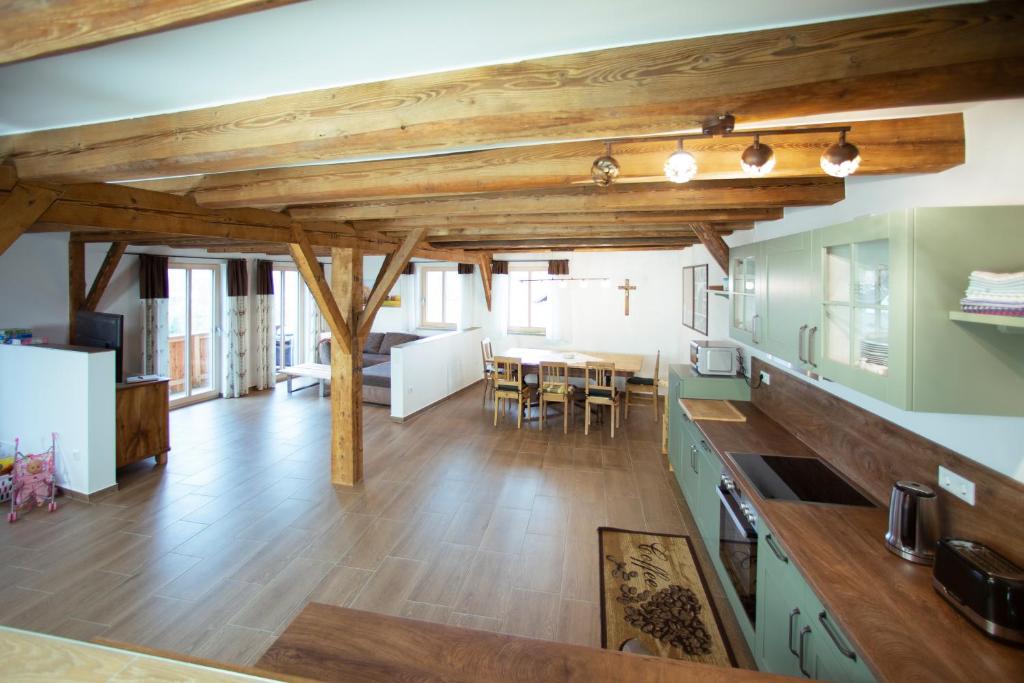 a kitchen and dining room with wooden beams at Ferienhaus Schreinerhaus in Viechtach