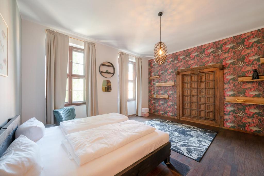 a bedroom with two beds in a room with a wall at Design Apartments - "Heiliger See" in Potsdam