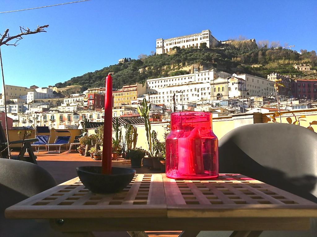 una mesa con una vela roja sobre una mesa con vistas en La Certosa, en Nápoles