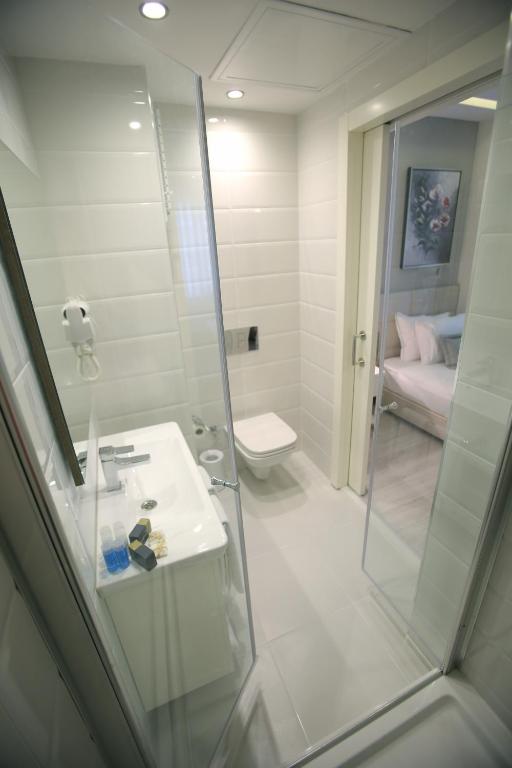 a bathroom with a shower and a sink and a toilet at Ravvda Hotel in Istanbul