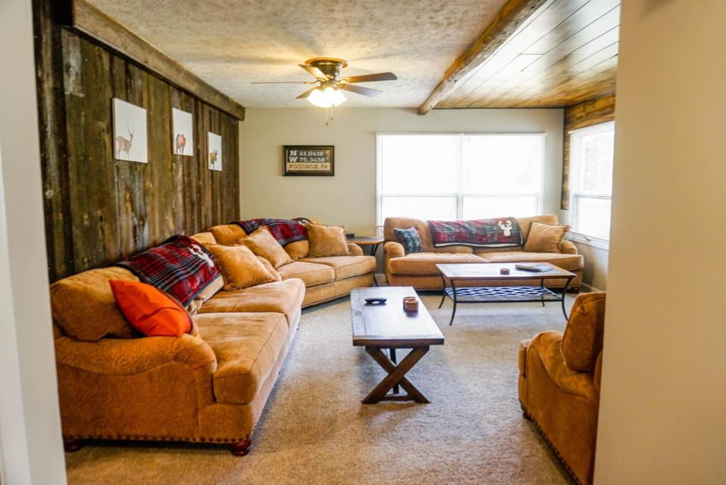 a living room with two couches and a table at Camelback Rd Rancher- On ONE ACRE & near attractions in Tannersville