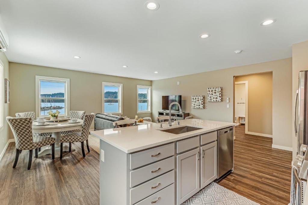 a kitchen and living room with a table and chairs at Liberty Bay Loft & Front Street Suite in Poulsbo