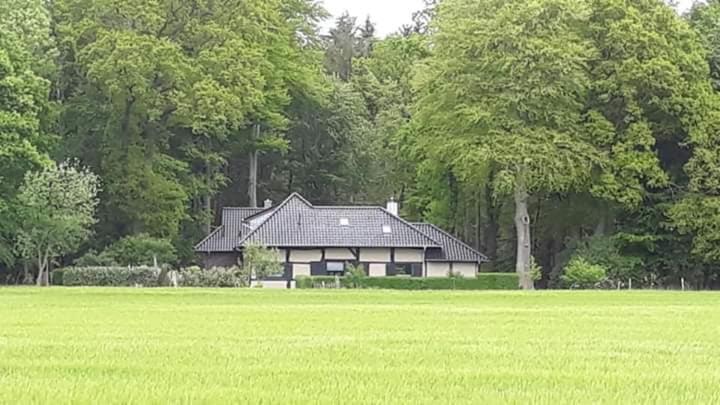 a house sitting in the middle of a field at Heuerhaus Gut Einhaus in Werlte