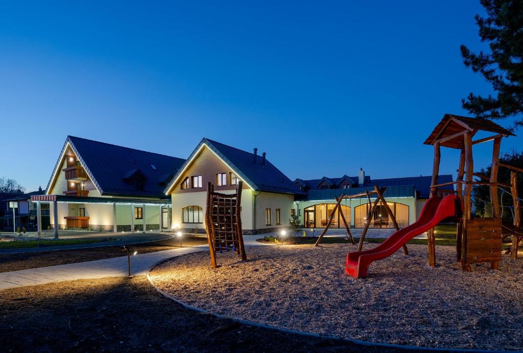 a playground in front of a house at night at Hotel Demänová **** in Liptovský Mikuláš