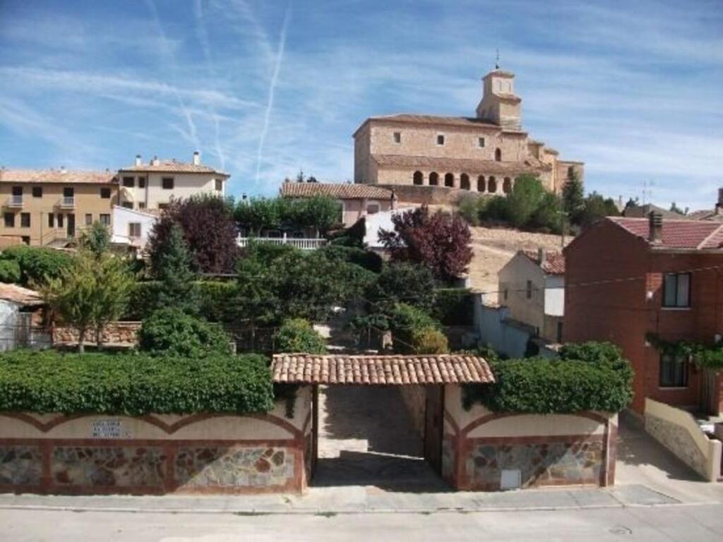 a view of a town with a castle in the background at La Huerta del Rivero in San Esteban de Gormaz