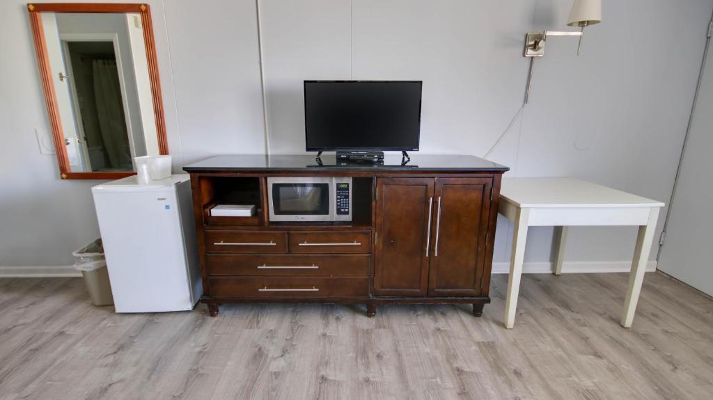 a tv sitting on top of a cabinet with a microwave at Rideau Oceanfront Motel in Ocean City