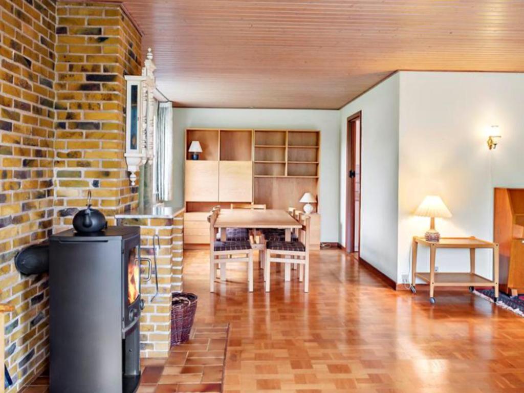 a living room with a brick wall and a fireplace at Very Nice villa in Rødby in Rødby