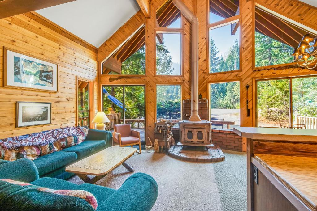 a living room with a couch and a fireplace at Kendall Place in Snoqualmie Pass