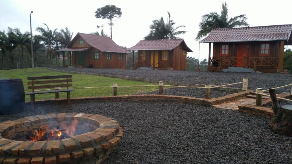 uma fogueira no meio de um quintal com casas em CASA DI PECORA - POUSADA RURAL em Lauro Müller