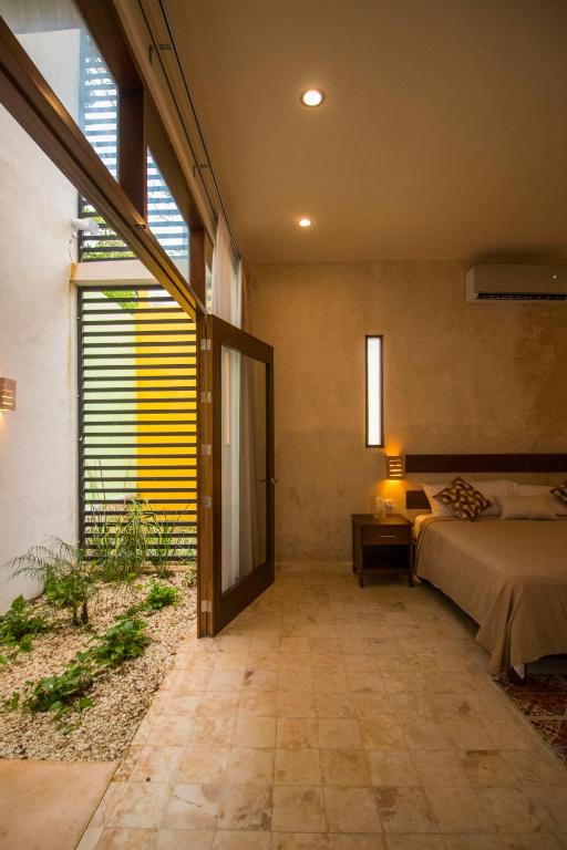 Una cama o camas en una habitación de Hotel Boutique SAYAB
