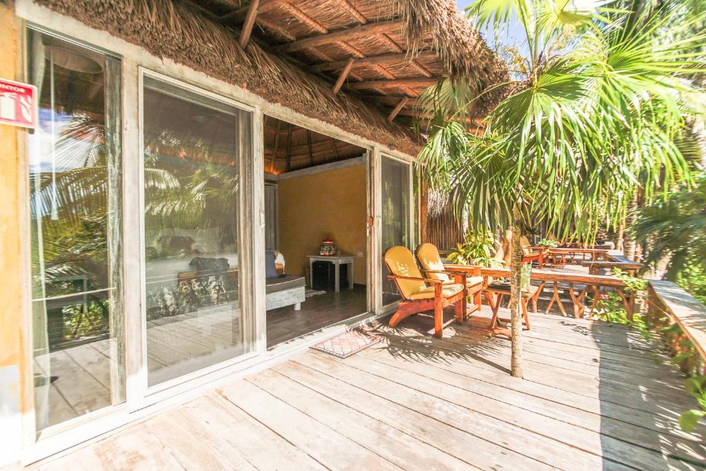 a patio area with a patio table and chairs at Villa Pescadores Tulum in Tulum