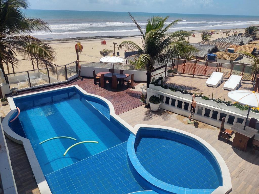 Blick auf den Pool und den Strand in der Unterkunft Hotel Portal Do Mar in Conde