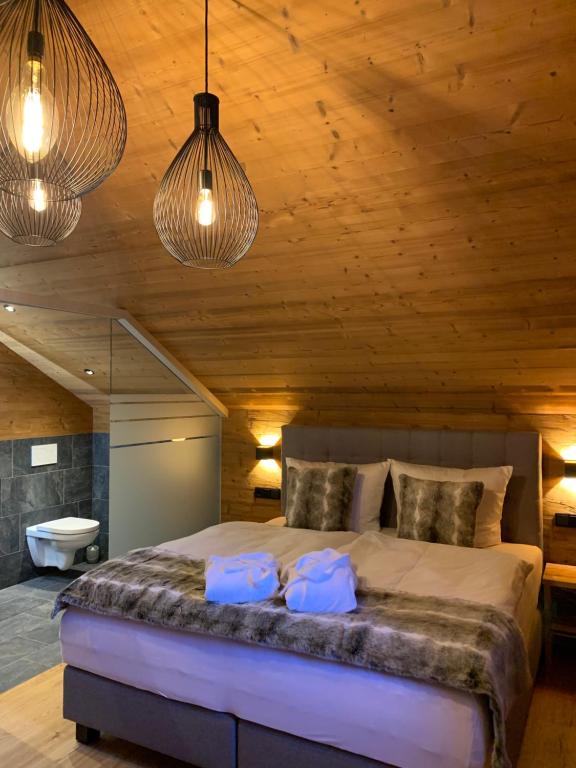 um quarto com uma cama grande e 2 almofadas em Chalet RelaxAlp Garfrescha em Sankt Gallenkirch