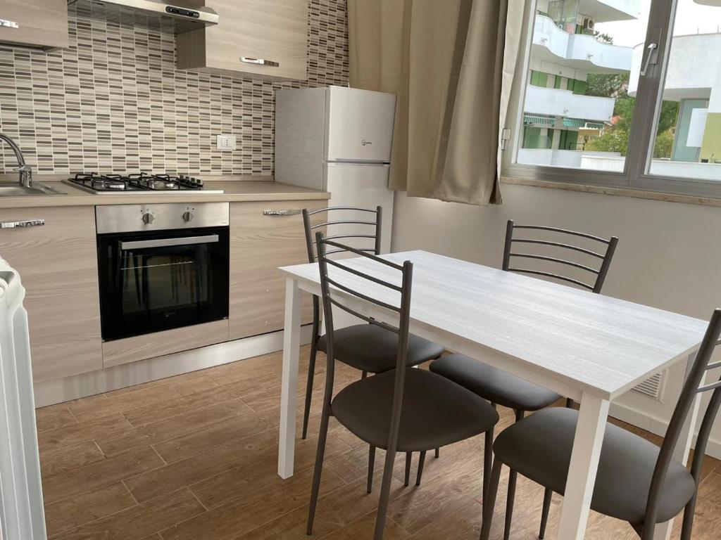 a kitchen with a table and chairs and a stove at My House in Montesilvano