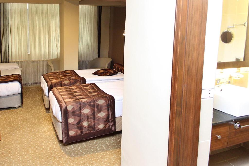 a hotel room with a bed and a bathroom at Marlight Boutique Hotel in İzmir