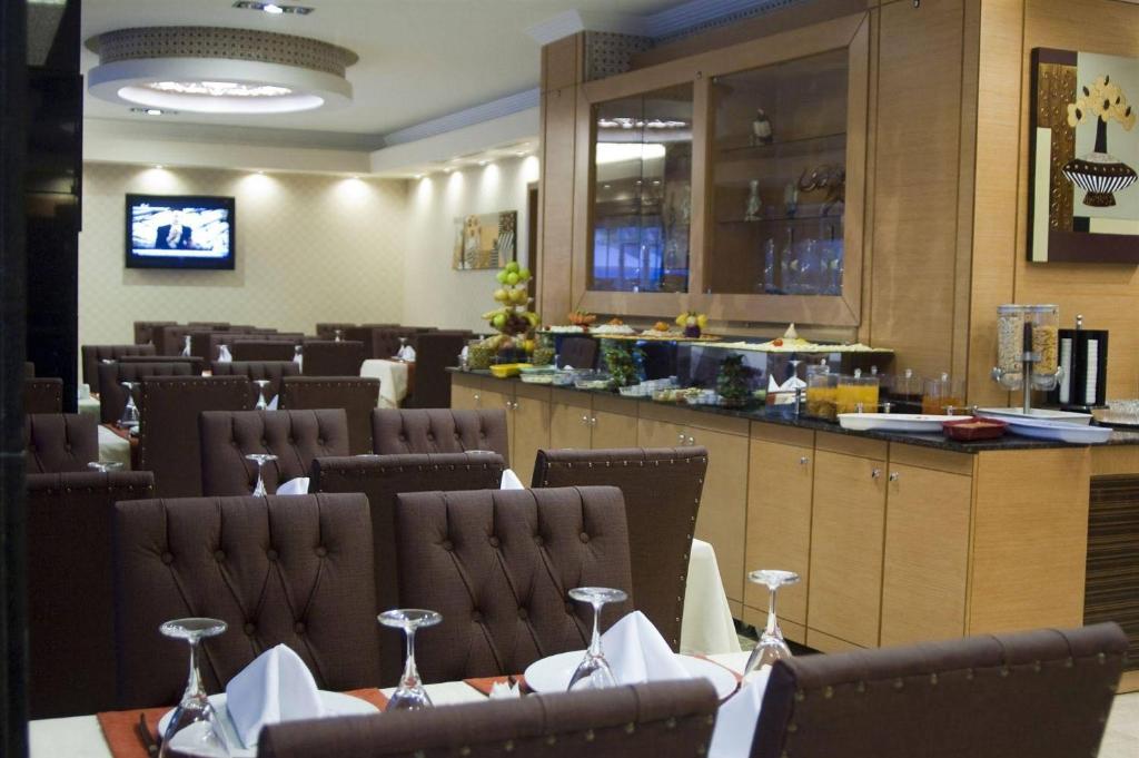 a restaurant with tables and chairs and a bar at Marlight Boutique Hotel in İzmir