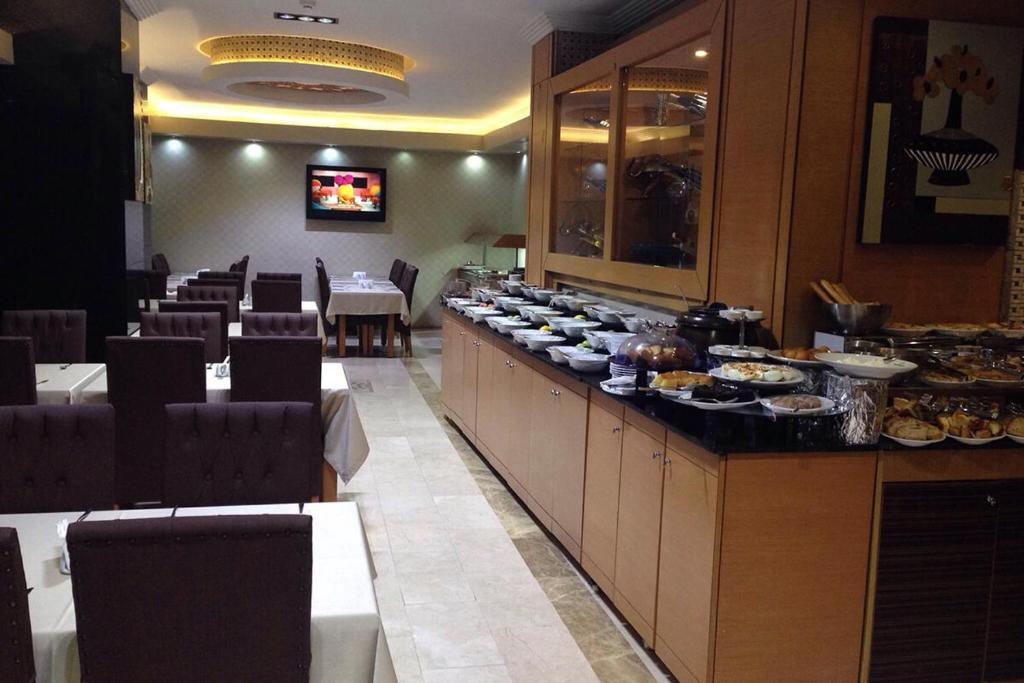 a buffet line with plates of food in a restaurant at Marlight Boutique Hotel in İzmir