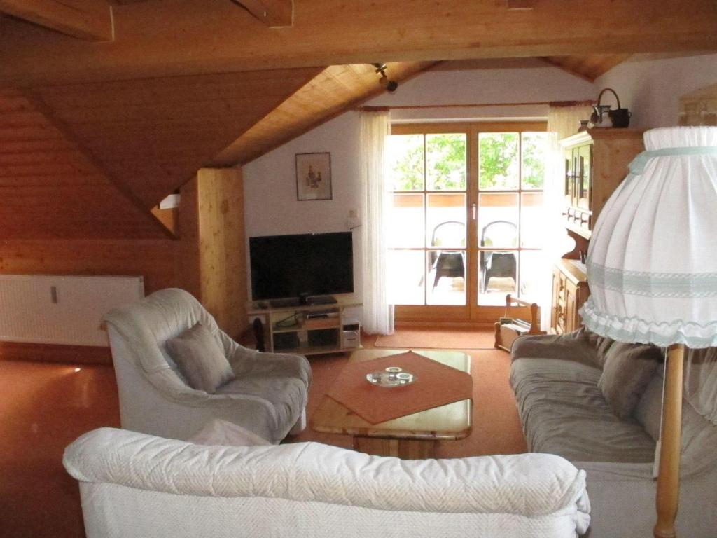 a living room with a couch and chairs and a tv at Ferienhaus-Haidweg-Wohnung-5 in Haidmühle