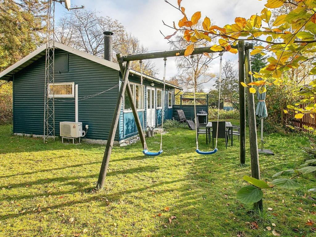 Children's play area sa 4 person holiday home in Gedser