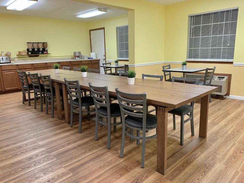 a conference room with a large wooden table and chairs at Seven Gables Inn in Branson